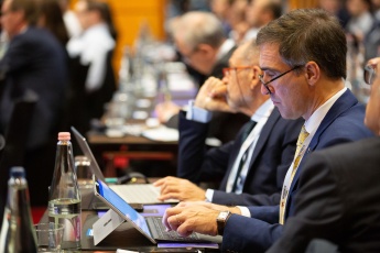 Businessman with a laptop, taking notes at a Budapest conference