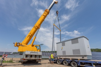 Crane lifting up an inverter station